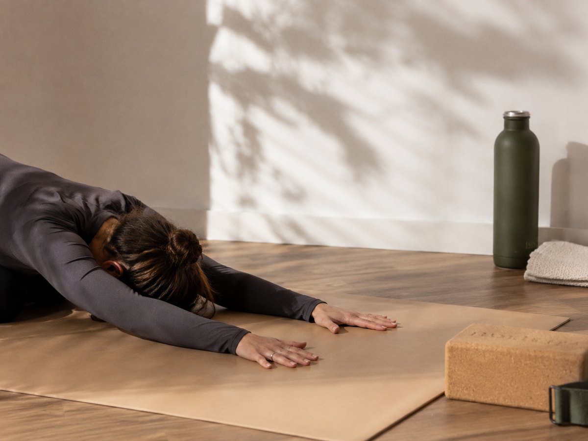 A grounded resting posture on a mat in the SiSU mat studio