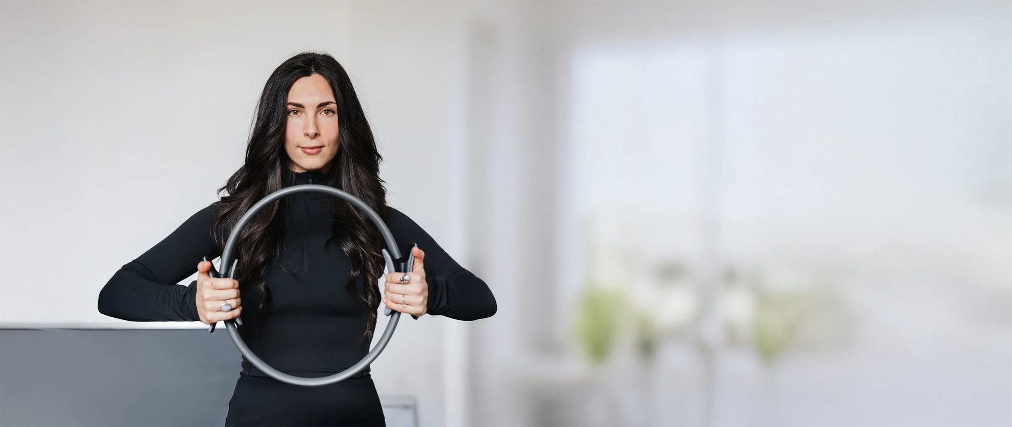 A Pilates instructor at SiSU Canberra holding a Pilates ring
